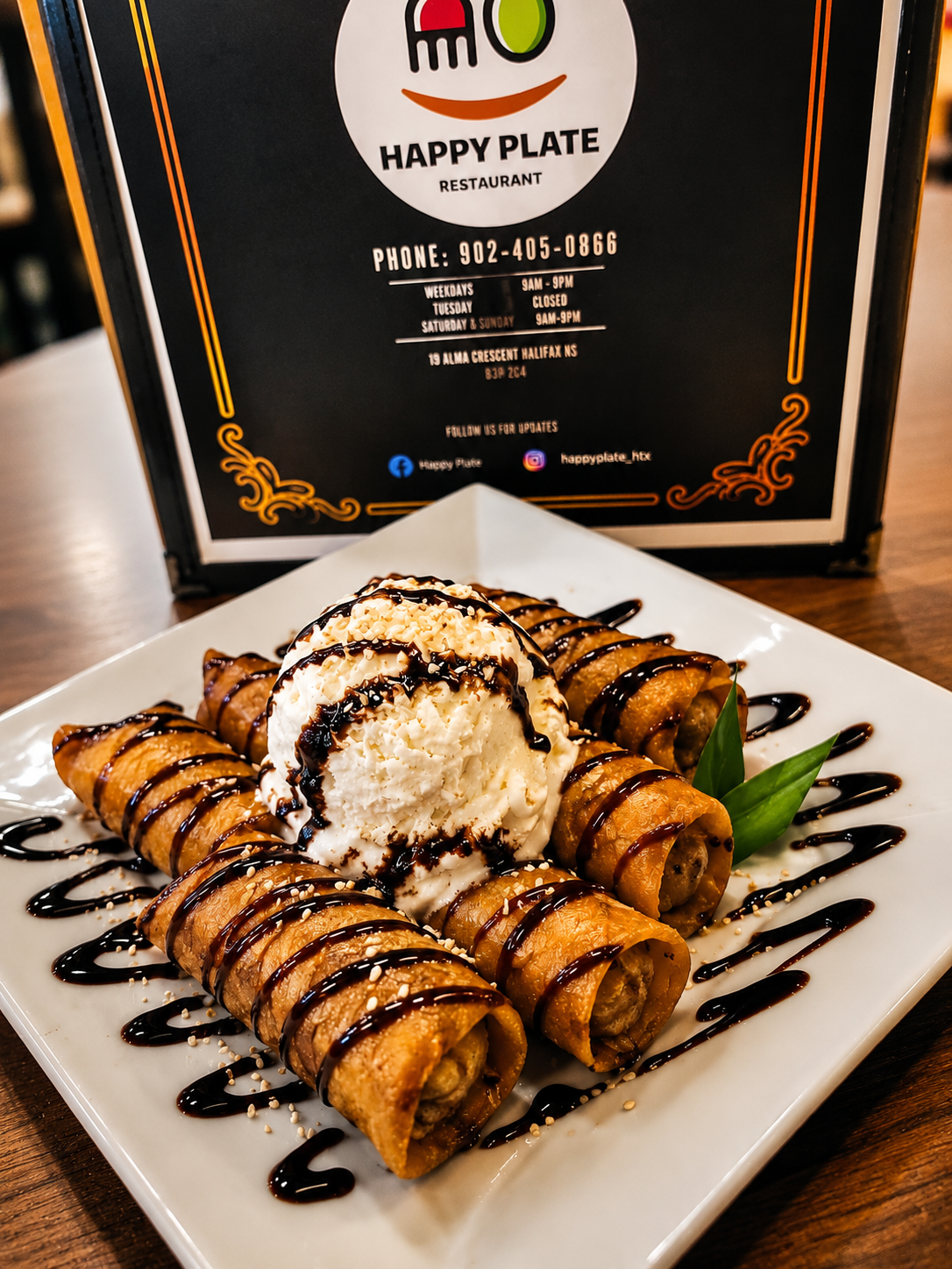 Golden dessert rolls with ice cream and chocolate drizzle